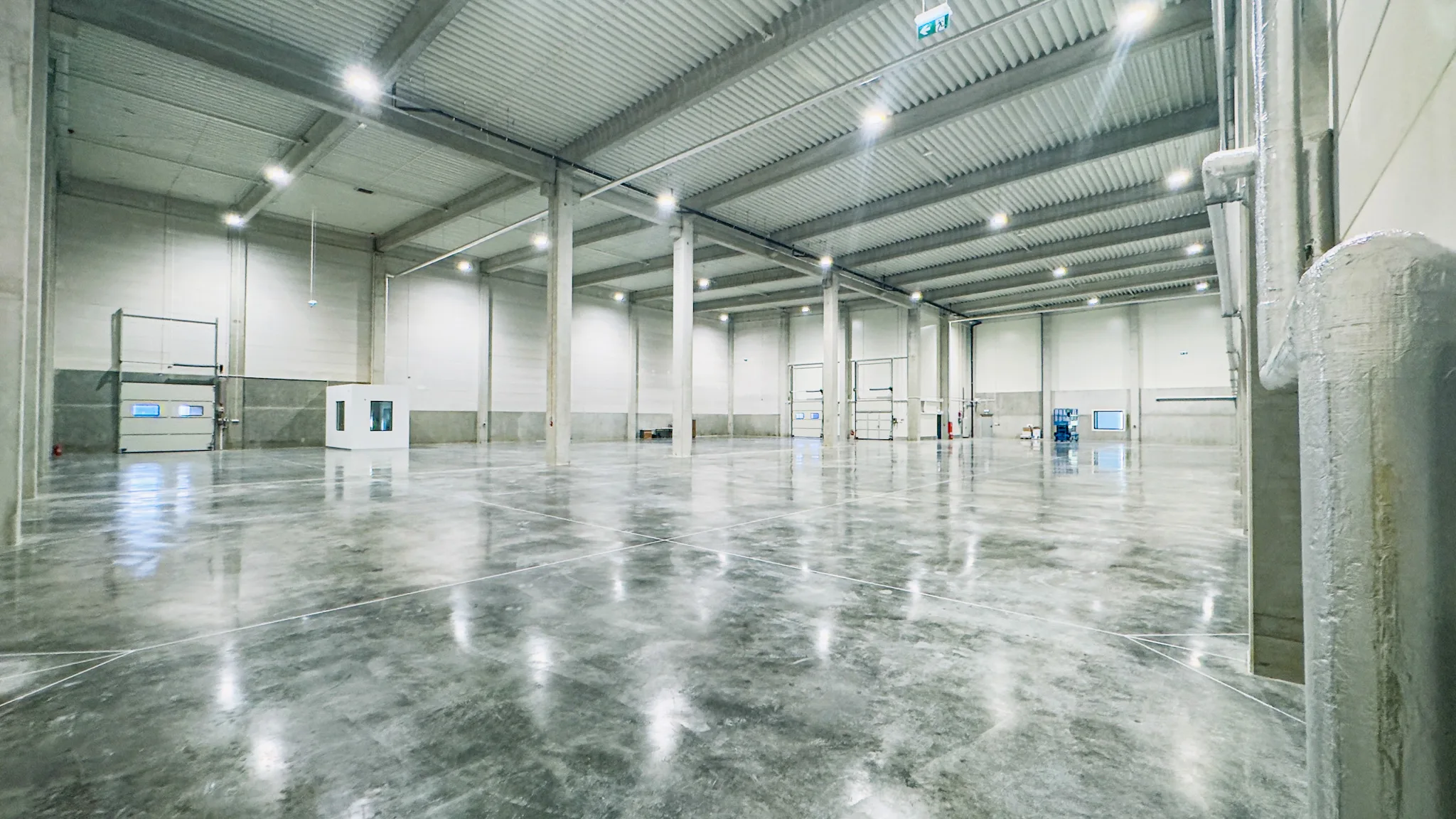 Wnętrze ukończonej hali magazynowej o wysokim standardzie wykonania, zrealizowanej przez VSYSTEM jako generalnego wykonawcę inwestycji budowlanej na Śląsku.